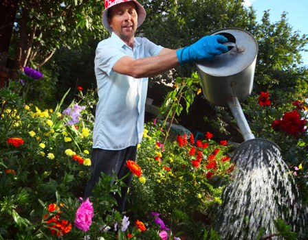Workers sorting garden waste for transfer to local processing